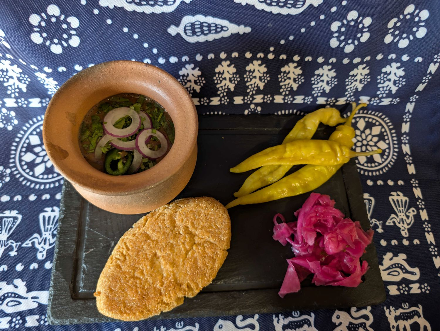 Beans cooked in clay pots with Mchadi (cornbread) and pickles